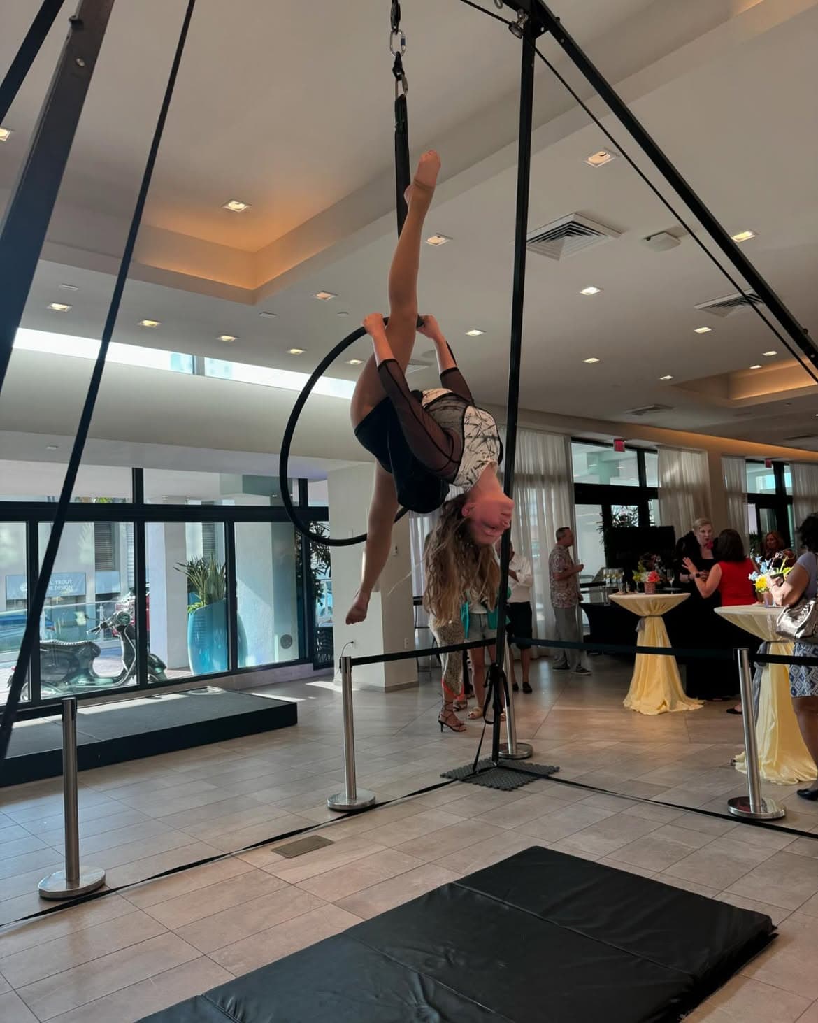 Rachel Baker performing an inverted split on an aerial lyra hoop